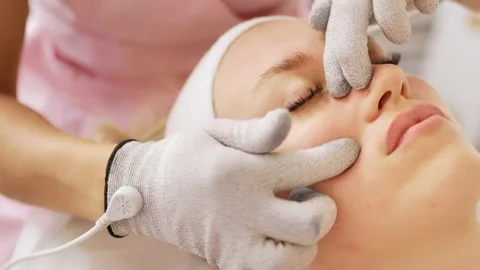 Beautician makes procedure on cheekbones with microcurrent Stock Footage 221262083