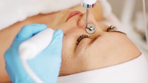 Beautician makes procedure on cheekbones with microcurrent Stock Footage 232797025