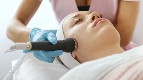 Beautician makes a procedure on the face with microcurrent Stock Footage 248241430