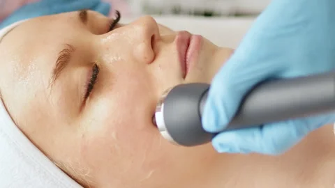 Beautician makes a procedure on the face with microcurrent Stock Footage 248241431