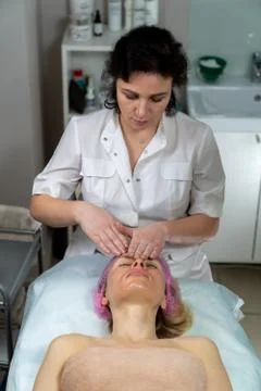 Beautician makes procedure for a girl with problem skin Stock Photos