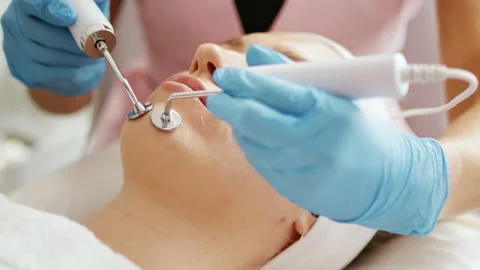 Beautician makes a procedure with microcurrent therapy Stock Footage 205317442