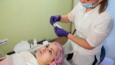 The beautician pulls out a disposable applicator for mesotherapy. Preparation Stock Footage 83608192