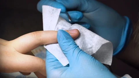 Beautician using a cuticle pusher. Making nails looking neat and clean Stock Footage 102779309
