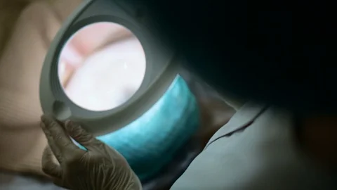 Beautician using magnifying glass while checking the client's face 库存影片 108582352
