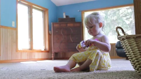 Beautiful 2 year old plays dollies and smiles Stock Footage 40027755