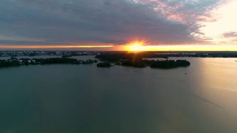 Beautiful 4K sunset. Sun shining behind and bellow clouds low from horizon Stock Footage 78760002