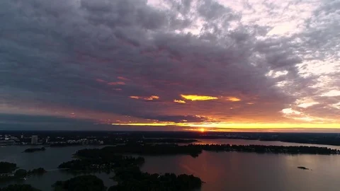 Beautiful 4K sunset. Sun shining low from horizon reflecting red and yellow Stock Footage 78761111