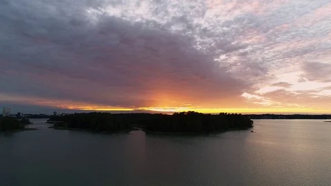 Beautiful 4K sunset. Sun shining behind and bellow clouds low from horizon Stock Footage 78762502