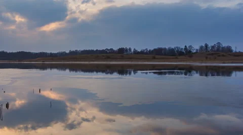 Beautiful 4k timelapse of lake with reflected cloudy sky on water surface Stock Footage 60823929