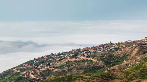 Beautiful 4K Timelapse over a small village on mountains and above sea of clouds Stock-Footage 131839586