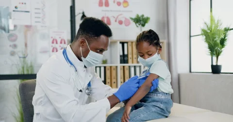 Beautiful 6-aged black-skinned girl in facial mask visiting her local Stock Footage 156260112