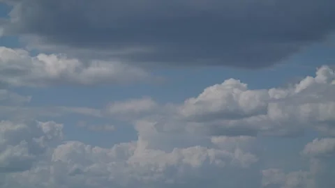 Beautiful 8K Time-lapse of Cumulus and Storm Clouds Moving Across Blue Sky Stock Footage 335289565