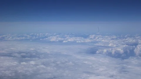 Beautiful above the cloud View through Airplane Illuminator To Sunset Stock Footage 96756944