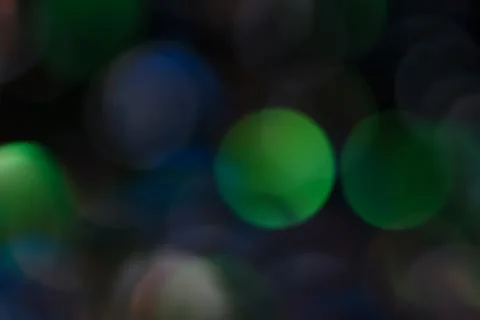 Beautiful abstract background from multi-layered defocused circles on a dark Stock Photos