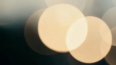 A beautiful abstract bokeh effect with warm golden lights on a dark background.  Stock Footage 309997693