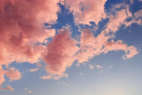 Beautiful abstract sky with pink clouds within summer sunset as a background Stock Photos