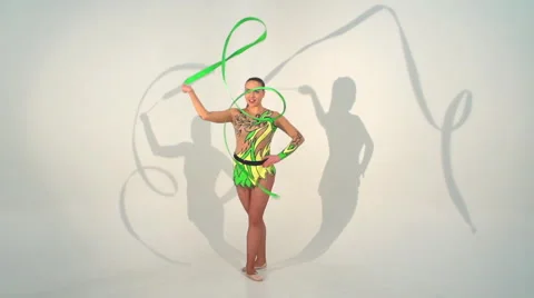 Beautiful acrobat dancing with a sash in slow motion Stock Footage 48858349