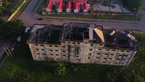 Beautiful aerial of a devastated building with a collapsed rooftop Stock Footage 320157194