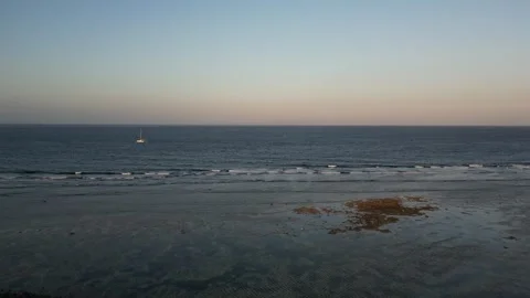 Beautiful Aerial Drone over a calm ocean during sunset in resort area, Bali Vídeo Stock 327044053