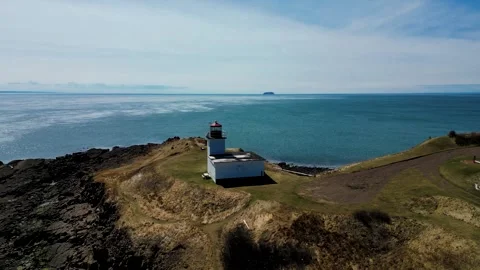 Beautiful Aerial Drone Pull Away Shot Of A Coastal Lighthouse Video stock 265163166
