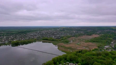 Beautiful Aerial drone view of a small town with a large pond and swamp Stock Footage 128596024