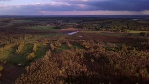 Beautiful aerial landscape with spring forest and meadow under stormy sky Vídeo Stock 153829016