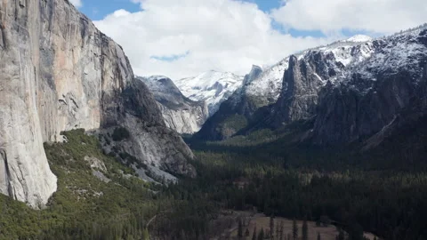 Beautiful aerial pullback view of Yosemite valley and granite cliffs in snow Stock Footage 270961366