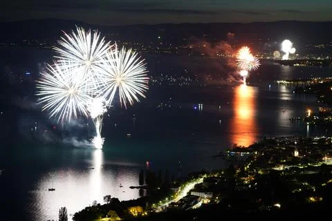 Beautiful aerial shot of fireworks exploding in the air above Lake Geneva in Swi Stock Photos