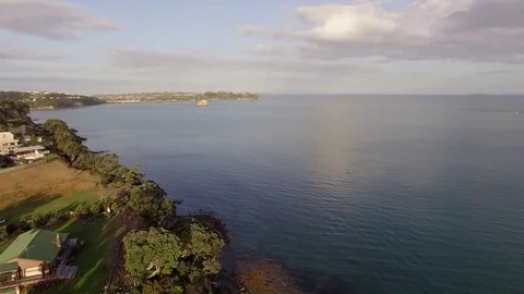 Beautiful aerial sunset view, New Zealand beach at Whangaparaoa, boat in the  Stock Footage 101682245