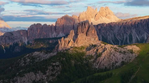 Beautiful aerial view over Cinque Torri glowing at sunset in the Dolomites Stock Footage 314959959