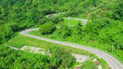 Beautiful aerial view of road between green tree forest in Thailand. Stock Footage 133749025