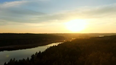 Beautiful aerial view of the sunset above the spruce forest, river and highway Stock Footage 122000700