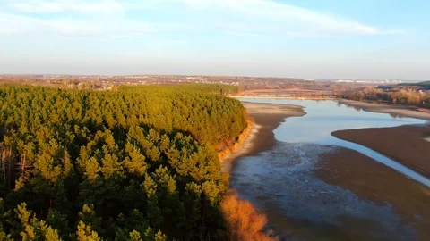 Beautiful aerial view of the sunset above the spruce forest, river and highway. Stock Footage 122000706