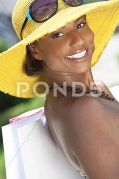 Beautiful african american woman smiling with shopping bags Stock Photos
