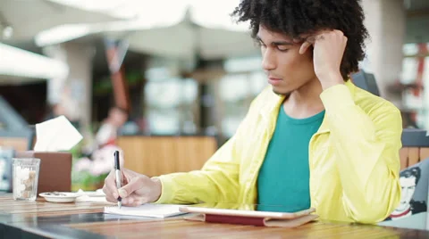 Beautiful African student learns using notebook and Tablet PC Stock Footage 38336505