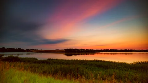 Beautiful after sunset sky over lake. Time-lapse video. Stock Footage 154390861