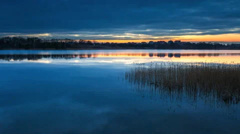 Beautiful after sunset time lapse of lake with sky reflected in water (4k) Stock Footage 61283904
