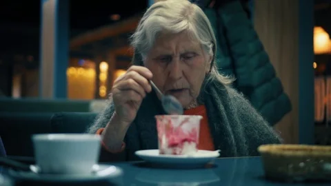 Beautiful aged lady is ending eating dessert at restaurant, she is pushing back Stock Footage 87178630