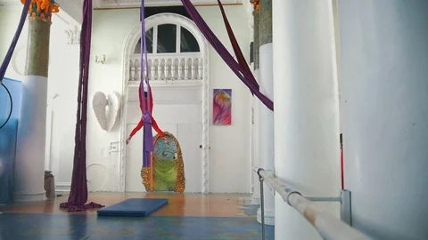 Beautiful air dancer makes acrobatic elements on aerial silk in a studio Stock Footage 88000826