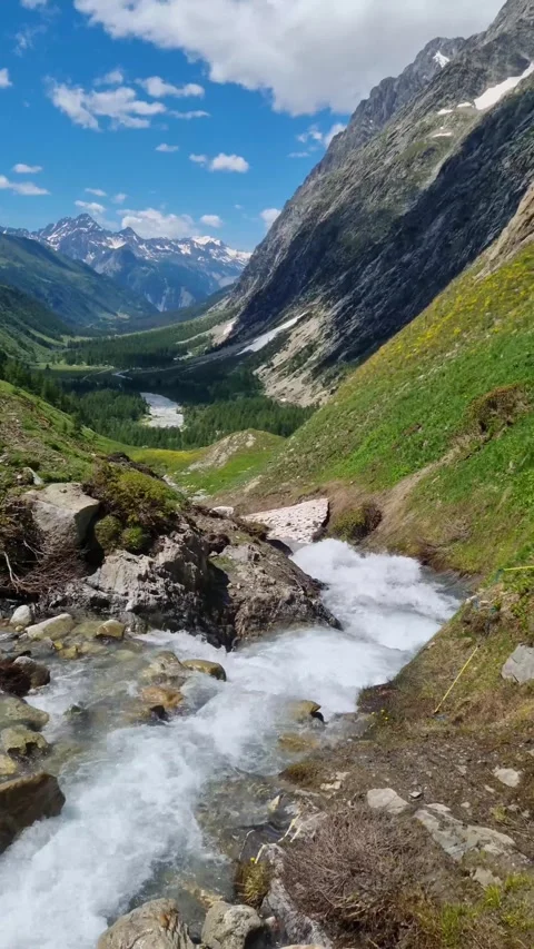 Beautiful alpine river stream coming down from the mountain glacier  Stock Footage 284668363