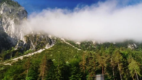 Beautiful Alps in Austria. Covered with forests, clouds can be seen above the Stock Footage 77416367