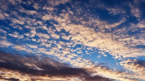 Beautiful altocumulus clouds drifting across blue sky during sunset in peaceful Stock-Footage 319842190