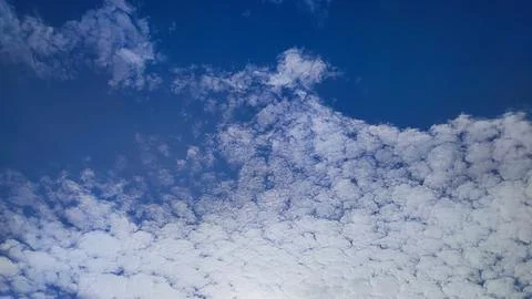 Beautiful altocumulus clouds pattern against bright blue sky, scenic sky ba.. Stock Photos