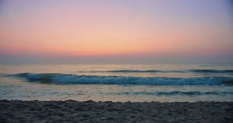 Beautiful amazing sunset over tropical ocean sea beach with pink purple sky and  Stock Footage 252248536