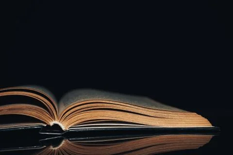 Beautiful ancient book pattern background for design. The book on a  black gl Stock Photos