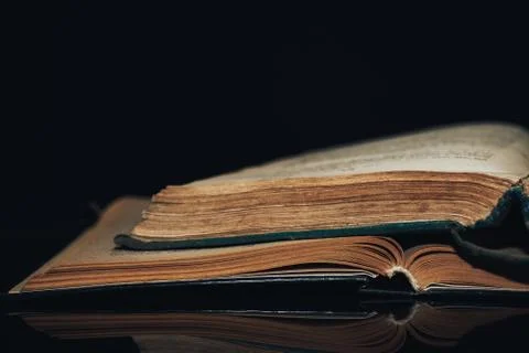Beautiful ancient book pattern background for design. The book on a  black gl Foto stock