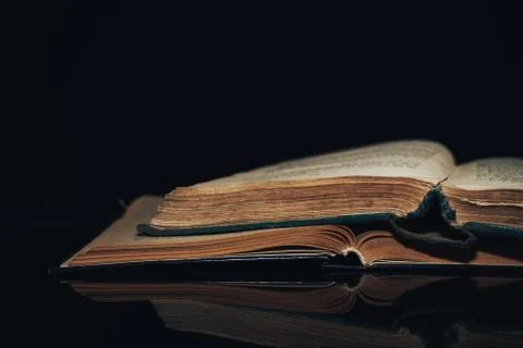 Beautiful ancient book pattern background for design. The book on a  black gl Stock Photos
