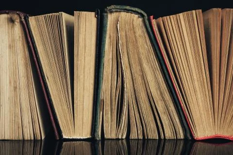 Beautiful ancient books. Pattern background for design. The book on a black g Stock Photos