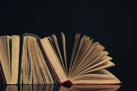 Beautiful ancient books. Pattern background for design. The book on a black g Stock Photos